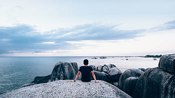 guy-man-rocks-boulders-coast-ocean-royalty-free-thumbnail.jpg