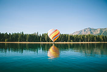 hot-air-balloon-blue-sky-lake-water-reflection-royalty-free-thumbnail.jpg